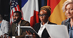 Press conference, tablet and woman with team for delegation, international government and panel. Summit, people and politician at speech for diplomacy discussion, global forum or policy update