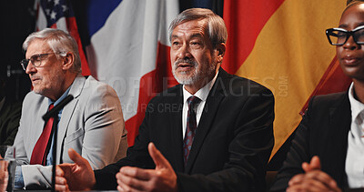 Buy stock photo Politician, forum or man with speech at press conference for economic relations, delegation or feedback. Global event, government panel and mature person with update on policy decision and diplomacy