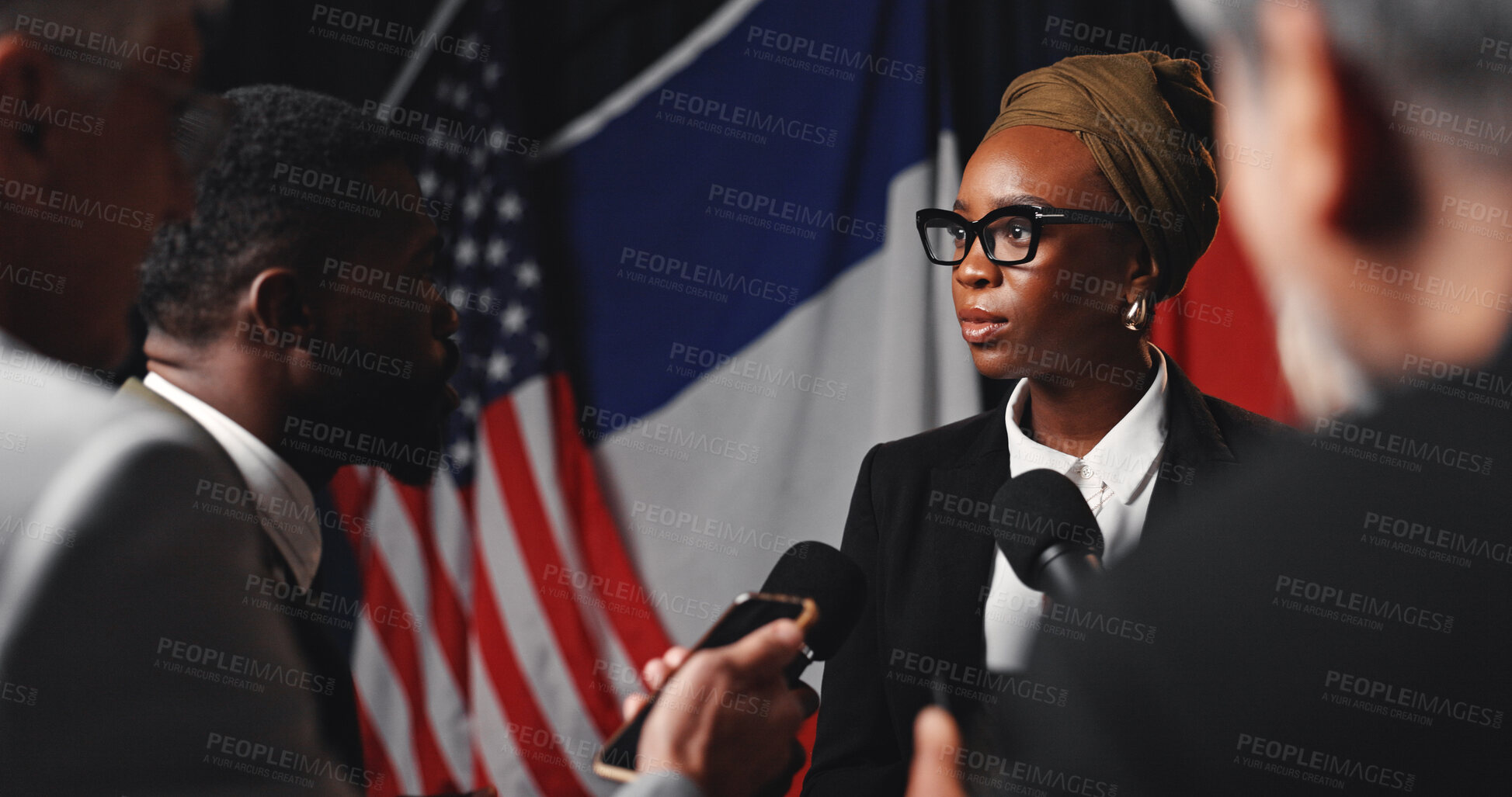 Buy stock photo Woman, press conference and flags at international convention, journalist group or interview at event. Person, speaker or ambassador with media, mic and talk for peace negotiation to stop global war