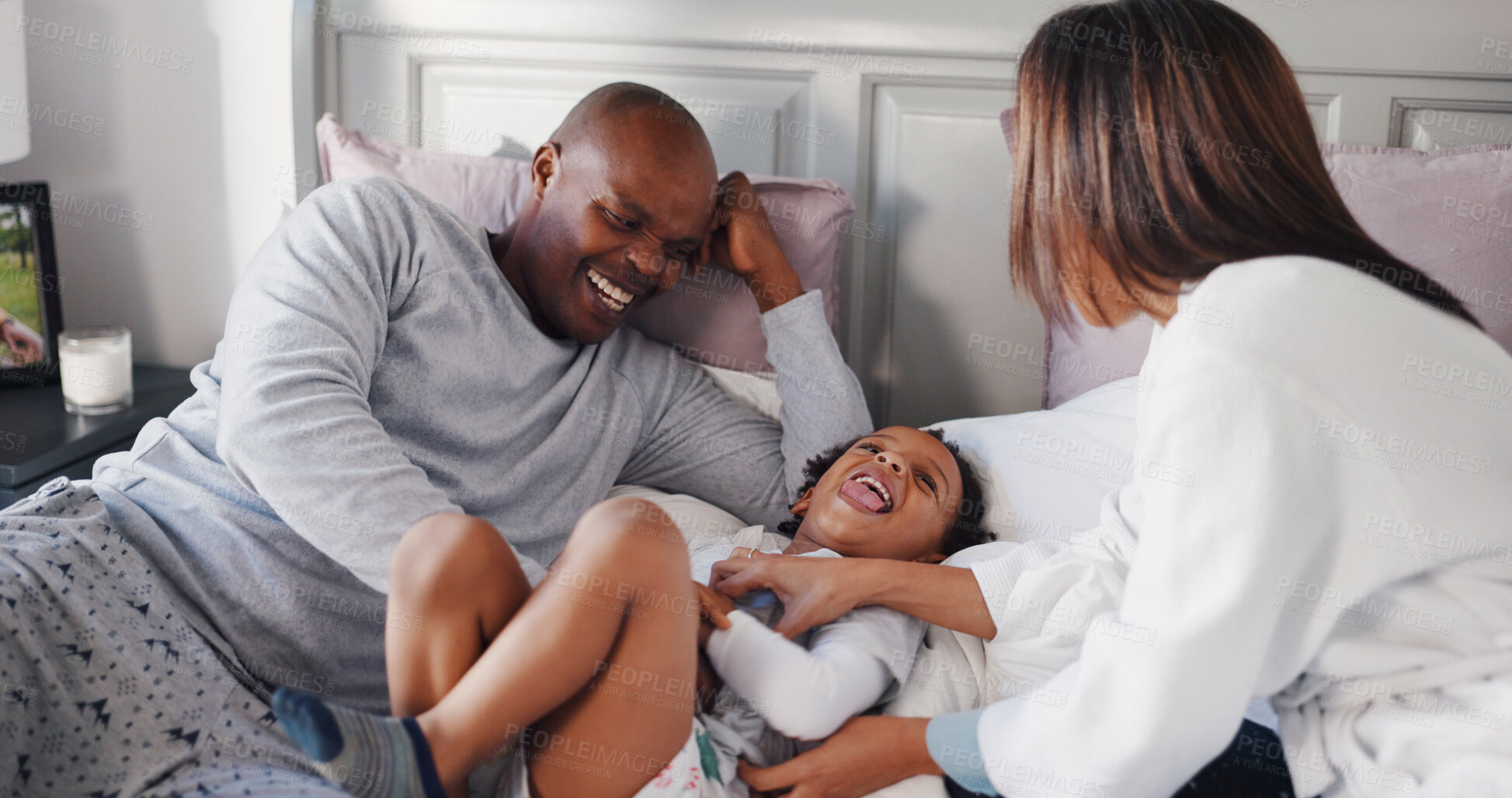 Buy stock photo Father, mother and son in bedroom with laughing, love or bonding together for support. African family, child and parents on bed of home for tickle game, humor and happiness or connection in morning
