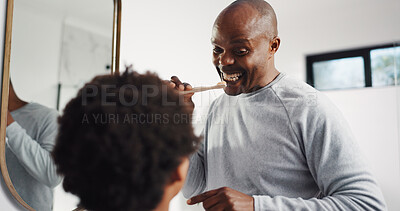 Buy stock photo Teaching, brushing teeth and father with kid in bathroom in home for dental care, hygiene or wellness. Learning, oral health and African dad with boy child for mouth routine in morning together.