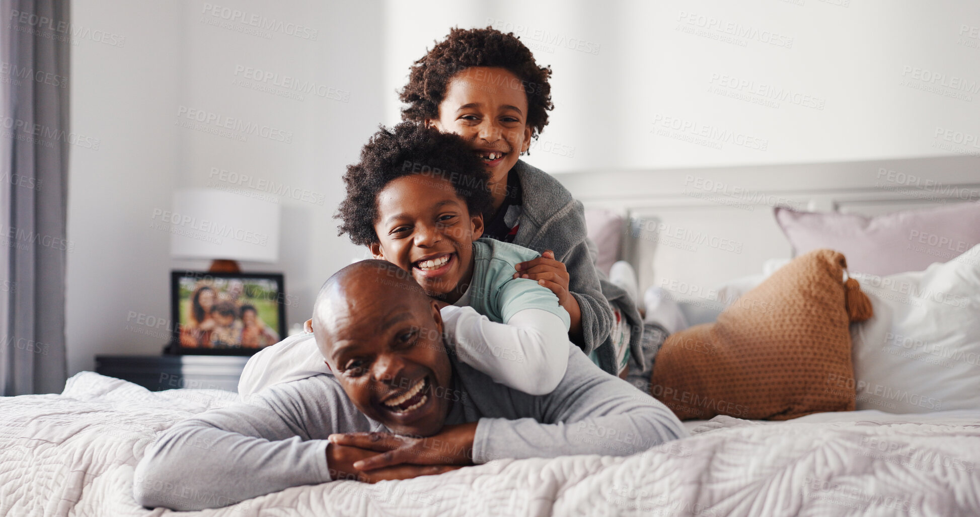 Buy stock photo Portrait, father and children in bedroom with laughing, love or brothers bonding together. African family, kids and single parent on bed of home for funny humor, happiness or connection in morning