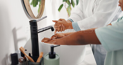 Buy stock photo Washing hands, child and mother in bathroom for cleaning, learning hygiene and bacteria safety. Parent, kid and water by sink in home for germ prevention, health and soap for teaching disinfection