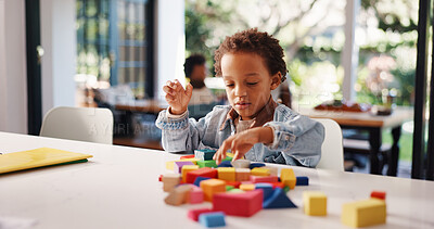 Buy stock photo Learning, kid or playing with building blocks in home for fine motor skills, problem solving or creativity. Education, african boy and toys on table for cognitive development and sensory imagination
