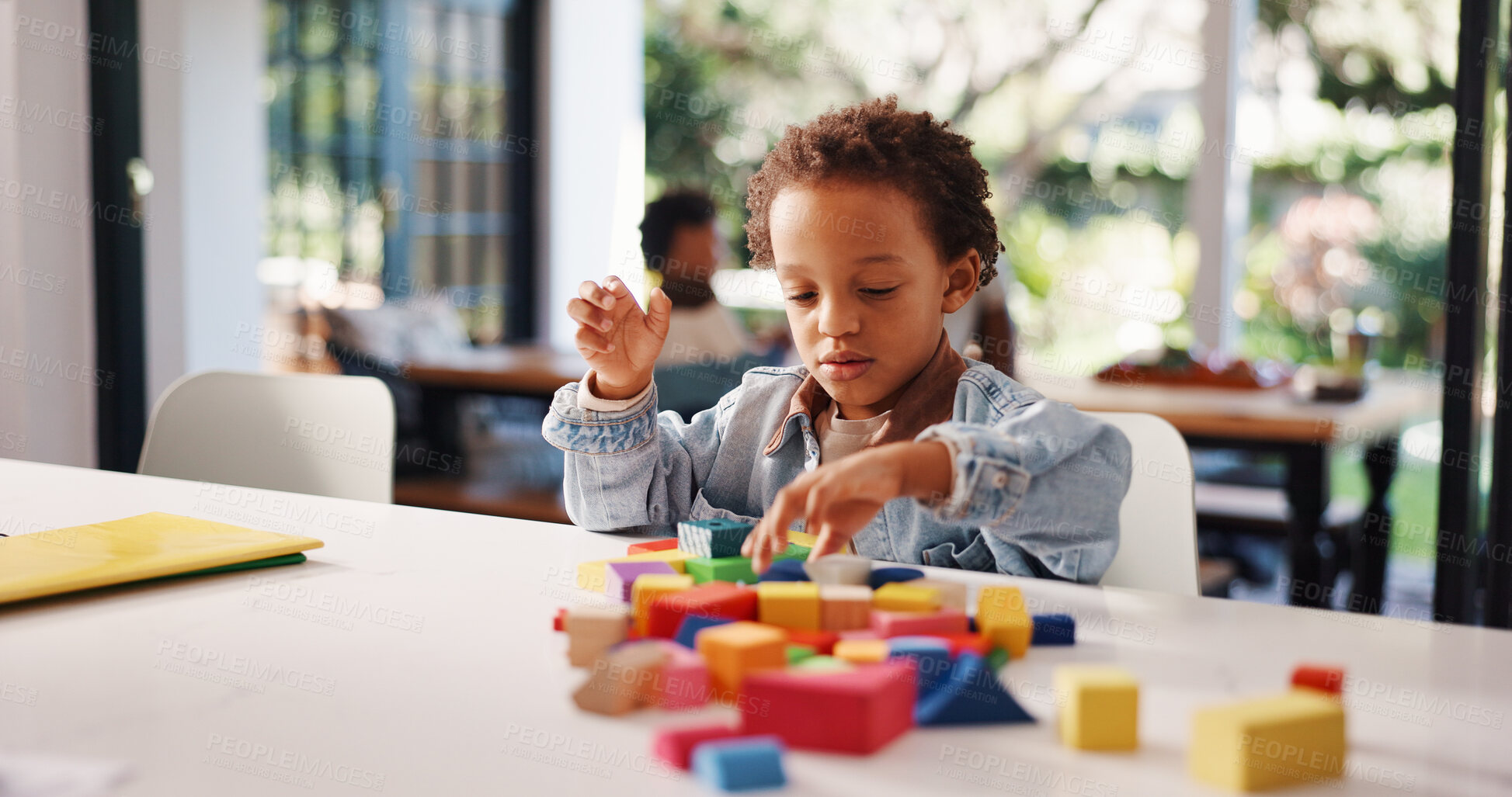 Buy stock photo Learning, kid or playing with building blocks in home for fine motor skills, problem solving or creativity. Education, african boy and toys on table for cognitive development and sensory imagination