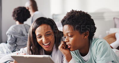 Buy stock photo Laughing, mom and child with tablet in bedroom, entertainment or watching cartoons with subscription. Happy, woman and bonding with boy on bed, home and streaming funny movies with tech and online