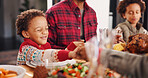 Christmas, prayer and family with food, boy and holding hands with tradition, unity and faith. Home, parents and mother with father, kids and Xmas meal with gratitude, worship and respect with feast