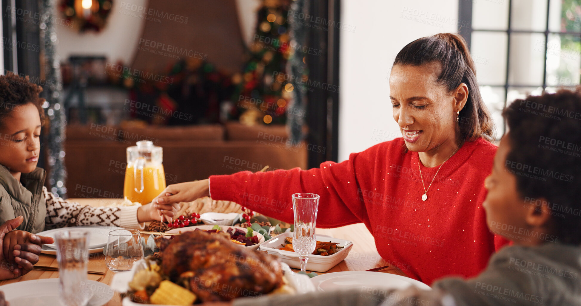 Buy stock photo Christmas, prayer and family with meal, home and holding hands with tradition, unity and chicken. Respect, parents and happy mother with kids, party and Xmas food with gratitude, worship and faith