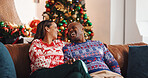 Christmas, sofa and interracial couple with laugh, tree and love in living room of house together. Joke, smile and man with woman, xmas and holiday or vacation bonding for festive season or tradition