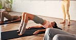 Yoga class, instructor and women with bridge pose in studio for wellness, morning exercise and flexibility. Pilates, personal trainer and group of people in health club for wellbeing, zen and workout