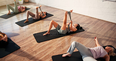 Buy stock photo Women, resistance band and stretching legs with exercise, training and muscle development at gym. People, group and fitness on floor for flexibility, mobility and above for pilates class at club