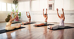 Yoga class, instructor and women with warm up in studio for wellness, morning exercise and flexibility. Pilates, personal trainer and group of people in health club for wellbeing, zen and workout