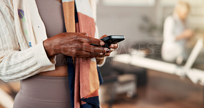 Buy stock photo Hands, smartphone and woman in studio, fitness and typing with digital app to track progress. Closeup, mobile user and healthy person in wellness center, cellphone and social media with connection