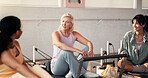 Pilates, conversation and happy women in studio for fitness advice, workout tips and exercise. Health club, instructor and friends in discussion, chat and talking on reformer machine for wellness