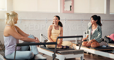 Buy stock photo Pilates, conversation and instructor with women in studio for fitness advice, workout tips or exercise. Health club, trainer and people in discussion, chat or talking on reformer machine for wellness