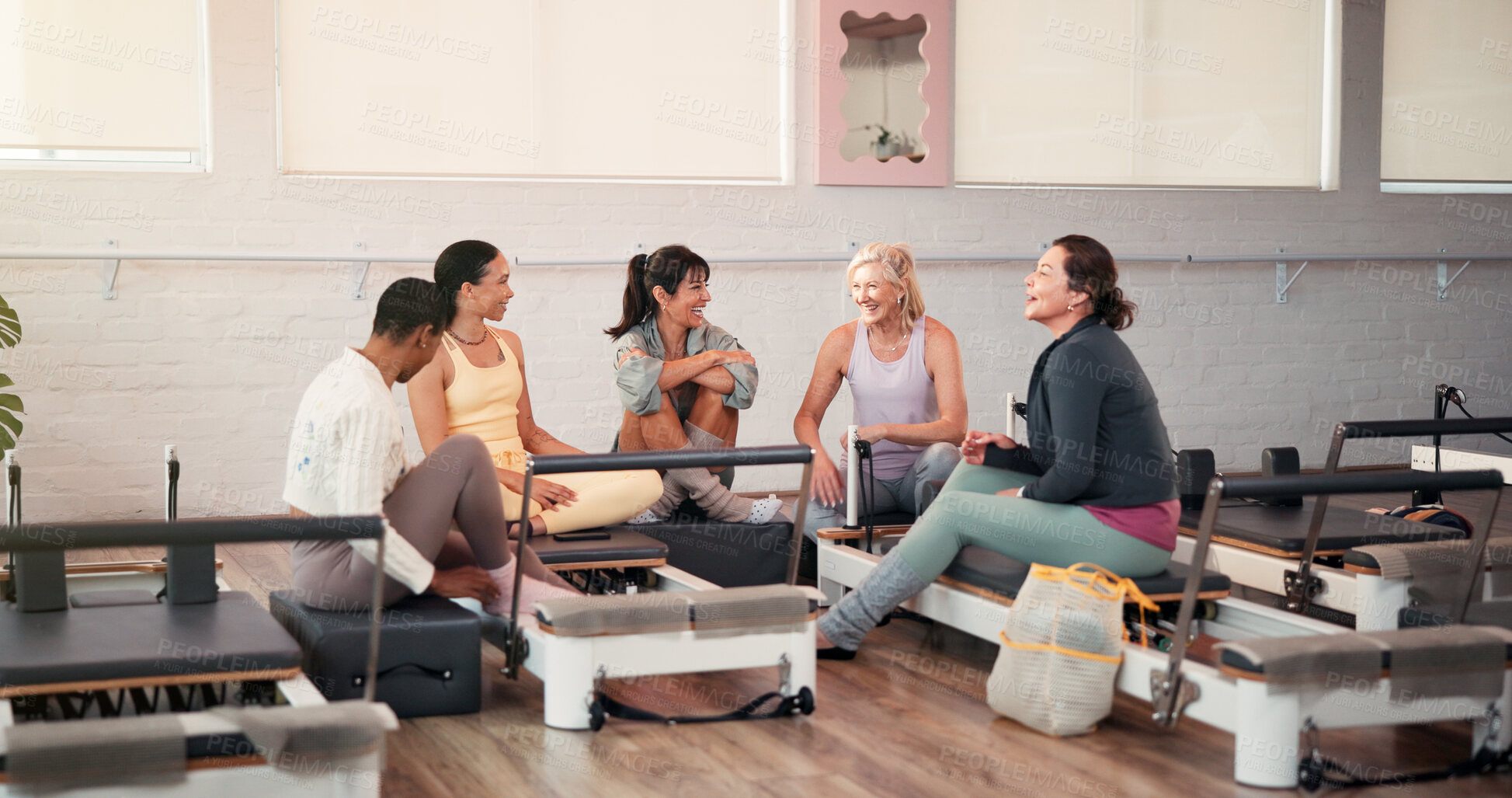 Buy stock photo Pilates, talking and trainer with women in gym for fitness advice, workout tips and exercise. Health club, instructor and people in discussion, chat or conversation on reformer machine for wellness