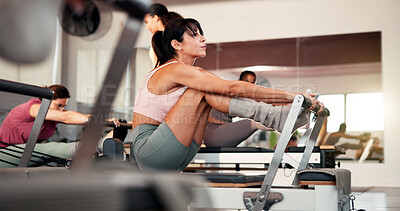 Buy stock photo Woman, reformer and pilates with machine for stretching, flexibility or physical exercise in gym. Active, female person or group with fitness equipment for workout, balance or resistance training