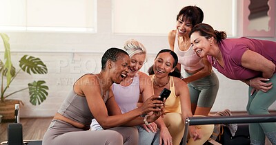 Buy stock photo Happy, team and women with smartphone in gym, fitness and checkup workout progress on web or online. Scroll, mobile and people with technology for exercise goals, wellness and positive health results
