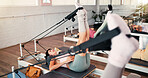 Pilates, studio and women with reformer machine for exercise, workout class and fitness. Personal trainer, health club and people stretching with equipment for core strength, wellness and mobility