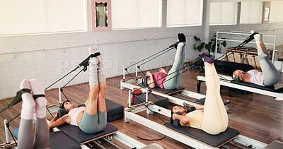 Buy stock photo Reformer, stretching and women in studio, balance and fitness with pilates training. Healthy people, resistance and group in wellness center, machine and exercise with challenge, endurance and power