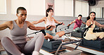Women, reformer and pilates class with resistance machine for stretching, flexibility or exercise in gym. Active, female people or group with fitness equipment for arm workout, balance or training