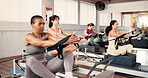 Women, reformer or stretching with machine for pilates class, flexibility or exercise in gym. Active, female people or group with fitness equipment for arm workout, balance or training in health club