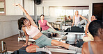 Pilates, class or instructor with demonstration on reformer for stretching form, guidance or lesson. Fitness club, women and coach with instructions on machine for body alignment or workout technique