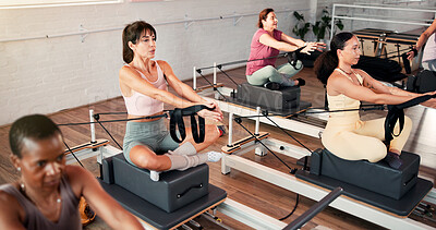 Buy stock photo Reformer, stretching and women in studio, strong and workout with pilates training. Healthy people, power and group with wellness, machine and exercise with challenge, endurance and resistance