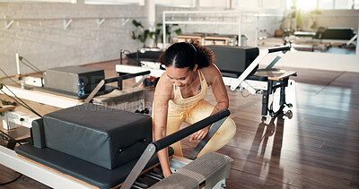 Buy stock photo Safety, inspection and woman with reformer, gym and adjust springs for workout resistance or fitness. Health club, pilates instructor and person with equipment, maintenance and setup for exercise