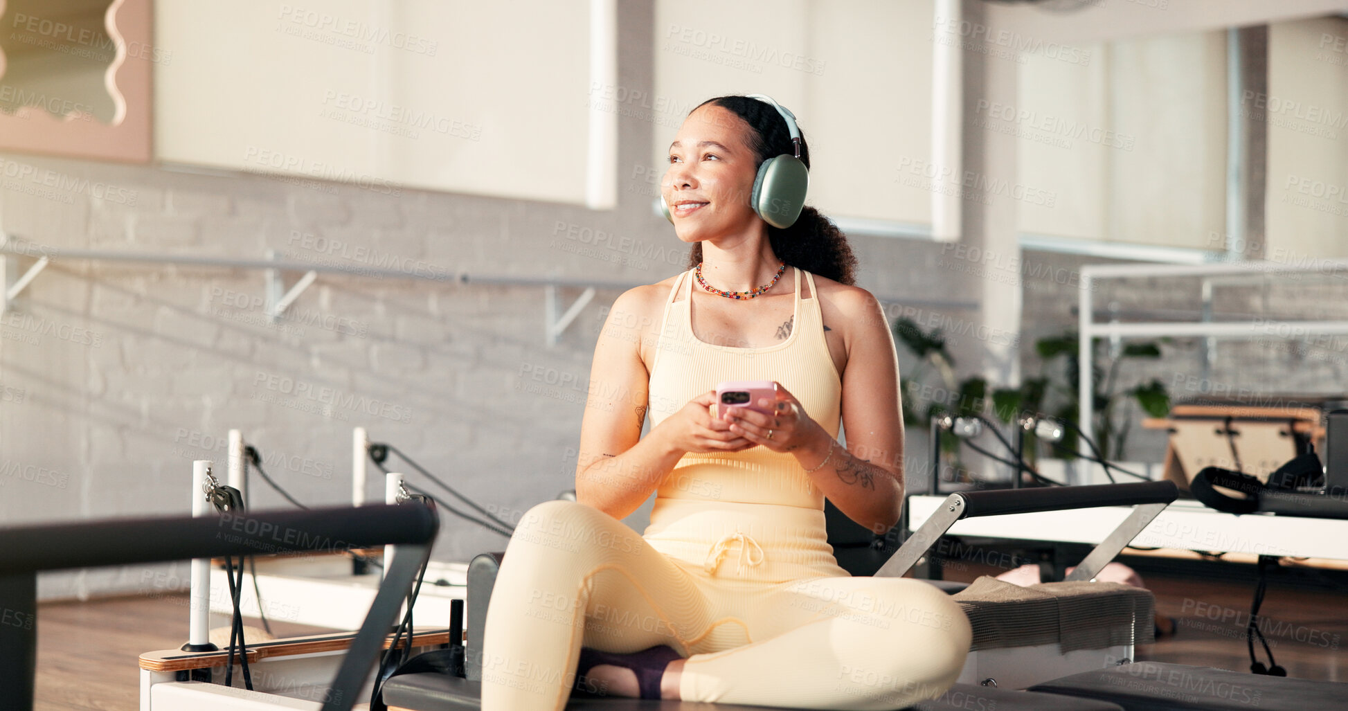 Buy stock photo Gym, headphones and woman with smartphone, think and streaming music on break, app and entertainment. Health club, reflection and person with mobile for song selection, happy and online for audio