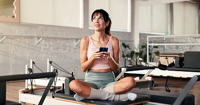 Buy stock photo Thinking, cellphone and woman in studio, exercise and typing with digital app to track progress. Contemplation, relax or healthy person in wellness center, smartphone and social media with connection