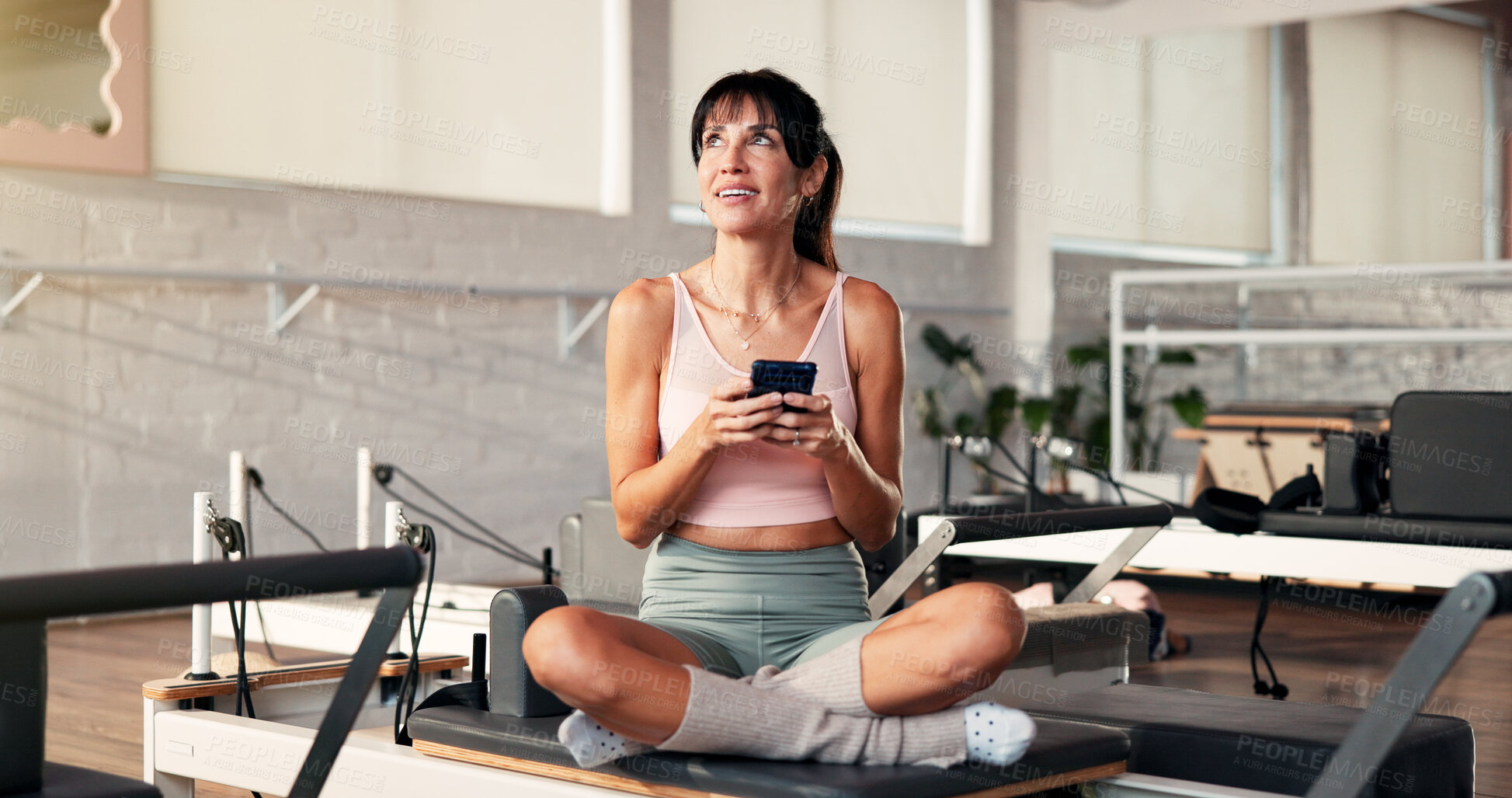 Buy stock photo Thinking, cellphone and woman in studio, exercise and typing with digital app to track progress. Contemplation, relax or healthy person in wellness center, smartphone and social media with connection