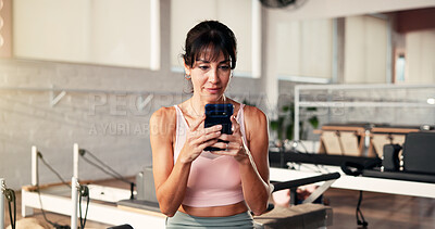 Buy stock photo Internet, smartphone and woman in gym, fitness or typing with digital app to track progress. Online reading, communication or healthy person in wellness center, cellphone or social media with network