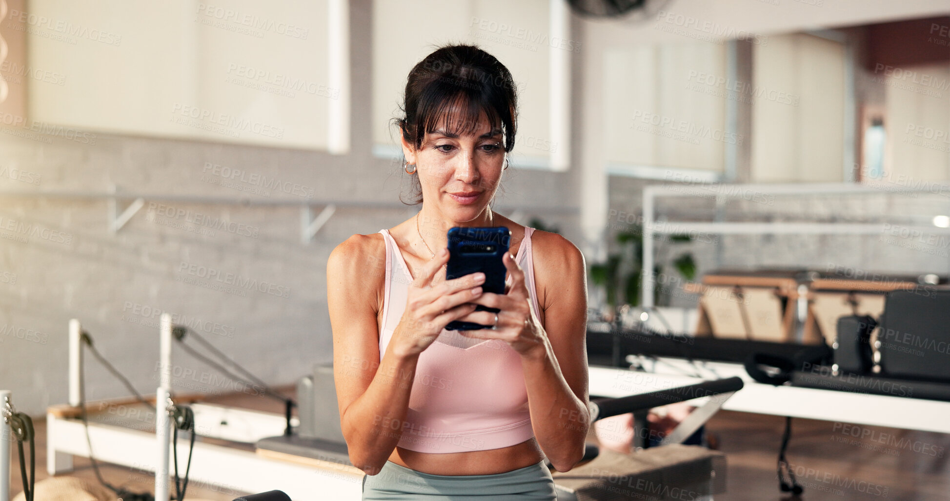 Buy stock photo Internet, smartphone and woman in gym, fitness or typing with digital app to track progress. Online reading, communication or healthy person in wellness center, cellphone or social media with network