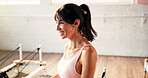 Happy, fitness and woman on reformer machine in studio for cool down exercise for wellness. Smile, equipment and calm female person with recovery on break for pilates class workout in health gym.