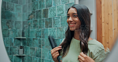 Buy stock photo Beauty, brushing hair and mirror for woman in bathroom of home for getting ready or morning routine. Hairbrush, reflection and smile of happy Indian person in apartment for daily haircare maintenance