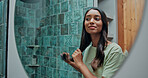 Beauty, hairbrush and mirror with woman in bathroom of home for getting ready or morning routine. Brushing hair, reflection and smile of happy Indian person in apartment for daily haircare treatment