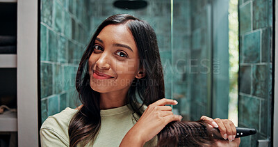 Buy stock photo Beauty, hairbrush and portrait of woman in bathroom of home for getting ready or morning routine. Brushing hair, mirror and smile of happy Indian person in apartment for daily haircare treatment