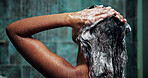 Shower, woman and shampoo for hair in bathroom, hygiene or cleaning with morning routine in home. Soap, person or wash scalp with water, cosmetics or haircare treatment for beauty with foam from back