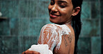 Woman, shoulder or soap in shower with water for cleaning, body care sponge or grooming in home. Happy female person, liquid or hygiene foam wash in bathroom with loofah, skincare product or wellness