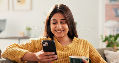 Buy stock photo Woman, phone and happy with coffee on sofa, texting and contact for online dating with chat in home. Person, smartphone and smile with cup, drink and mobile app for social network on couch at house