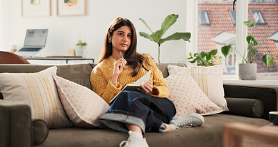 Buy stock photo Woman, thinking and writing in diary on sofa, relax and daydream with inspiration in living room at house. Person, notebook and reflection on couch for perspective, insight or memory at apartment