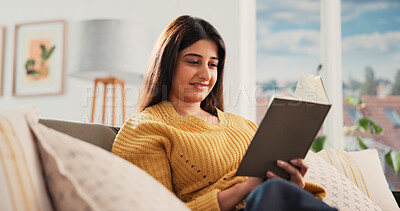 Buy stock photo Reading, smile and Indian woman on sofa with book, calm and literature hobby in weekend break. Free time, study and female person in house with novel, relax and fantasy story on Saturday afternoon.