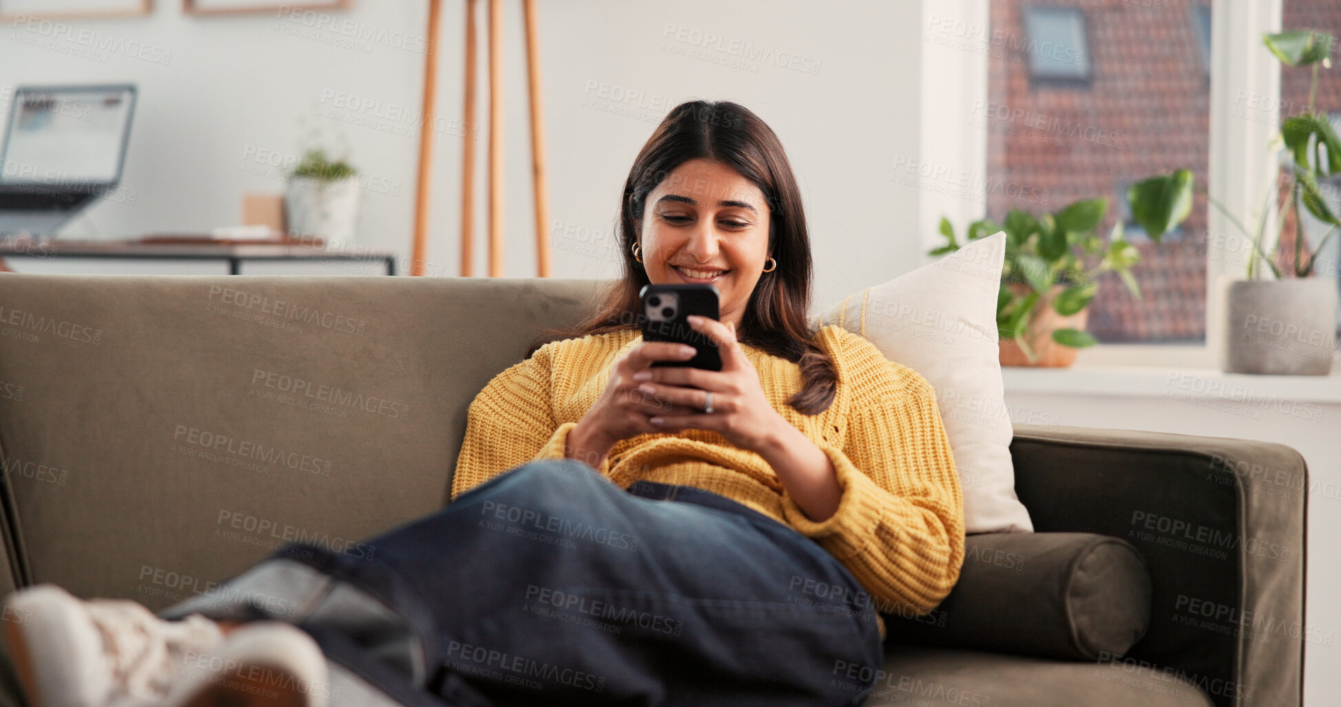 Buy stock photo Cellphone, happy and woman on sofa in home with networking, communication or social media on mobile app. Smile, relax and female person with phone for texting, contact or chatting in living room.