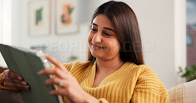 Buy stock photo Streaming, happy or Indian woman on sofa with tablet, online reading or video update on social media. Smile, scroll or girl in house with tech, e book subscription or multimedia browse on digital app