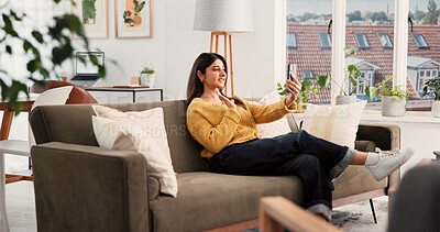 Buy stock photo Smartphone, video call and woman on sofa in home with communication, greeting and online conversation. Happy, waving and female person with phone for virtual discussion with networking in living room