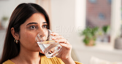 Buy stock photo Woman, relax and drinking water with glass at house space for hydration, refreshing liquid and detox. Thirsty, person and cold beverage for nutrition, digestion benefits and minerals for gut health
