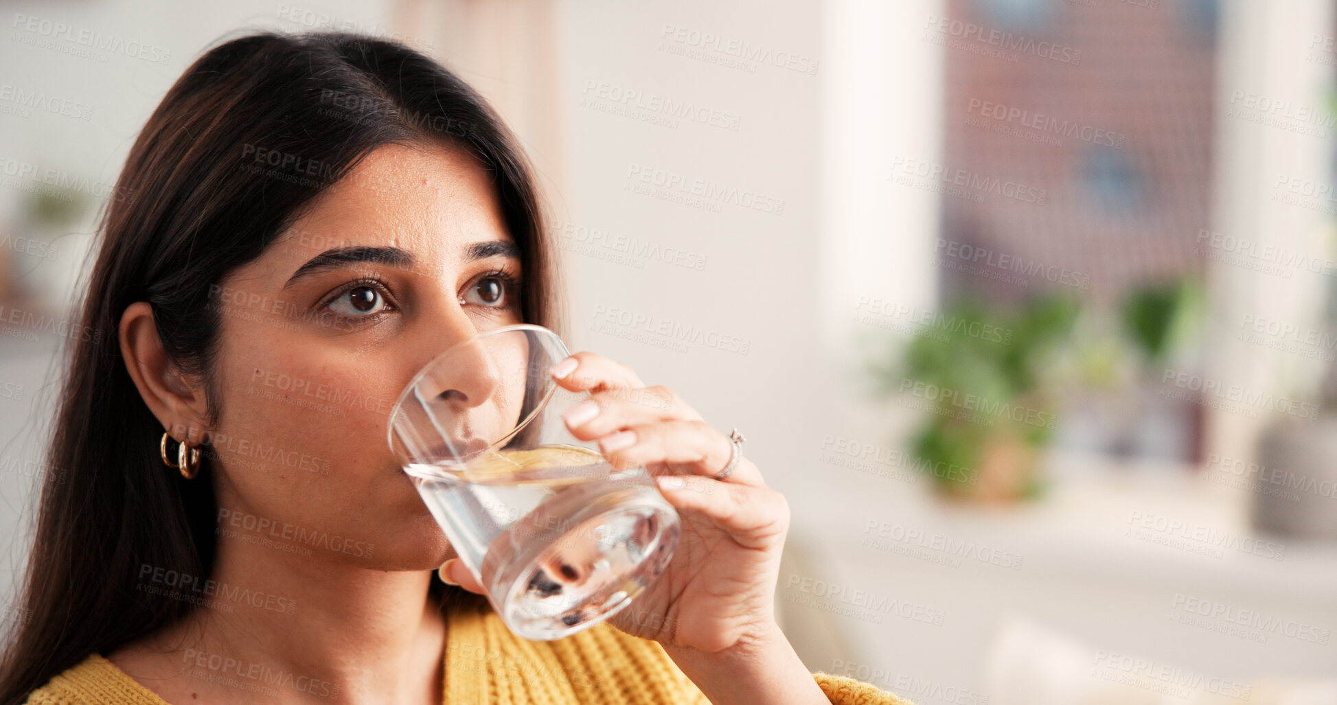 Buy stock photo Woman, relax and drinking water with glass at house space for hydration, refreshing liquid and detox. Thirsty, person and cold beverage for nutrition, digestion benefits and minerals for gut health