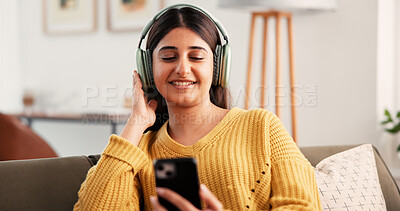 Buy stock photo Mobile, headphones and woman with music in home, streaming podcast or listening to sound. Smile, smartphone and person with audiobook in living room, online radio and relax with digital app on sofa
