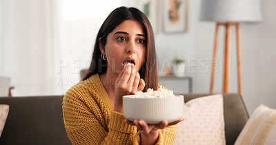 Buy stock photo Woman, eating and watching tv on sofa with popcorn for entertainment, film and relax on weekend. Female person, streaming service and subscription with snack in house for movie, show and series.